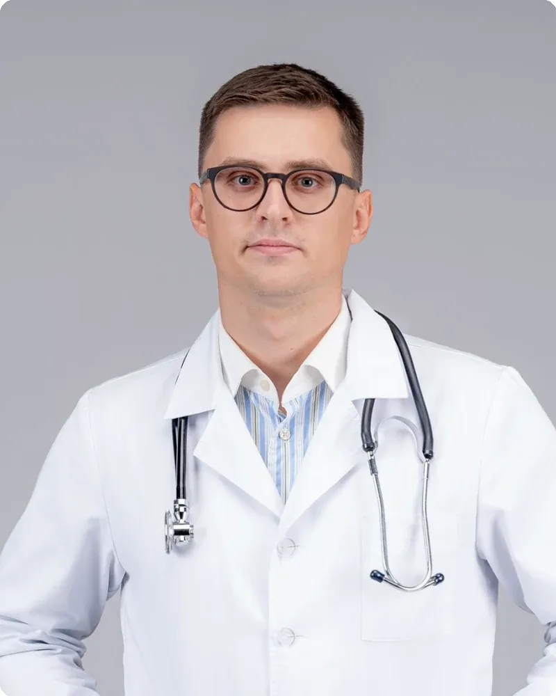 White lab coat over solid shirt, stethoscope optional. The classic physician headshot.
