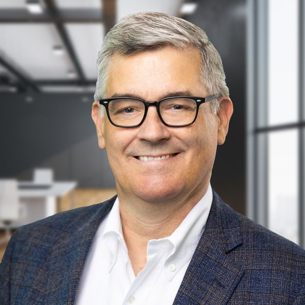 Corporate headshot example, real photo enhanced by AI