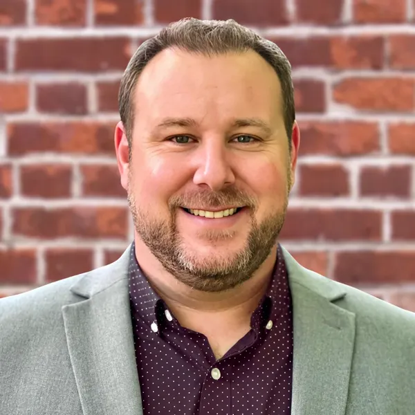 Medical headshot example: placement mockup, real photo enhanced by AI