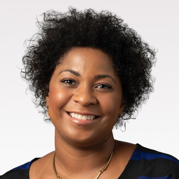 Corporate headshot example, real photo enhanced by AI