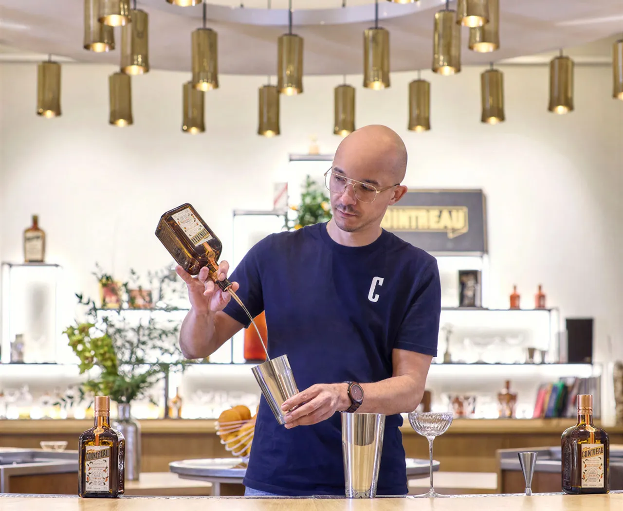 Barkeeper mixing a drink at le Carré, Angers