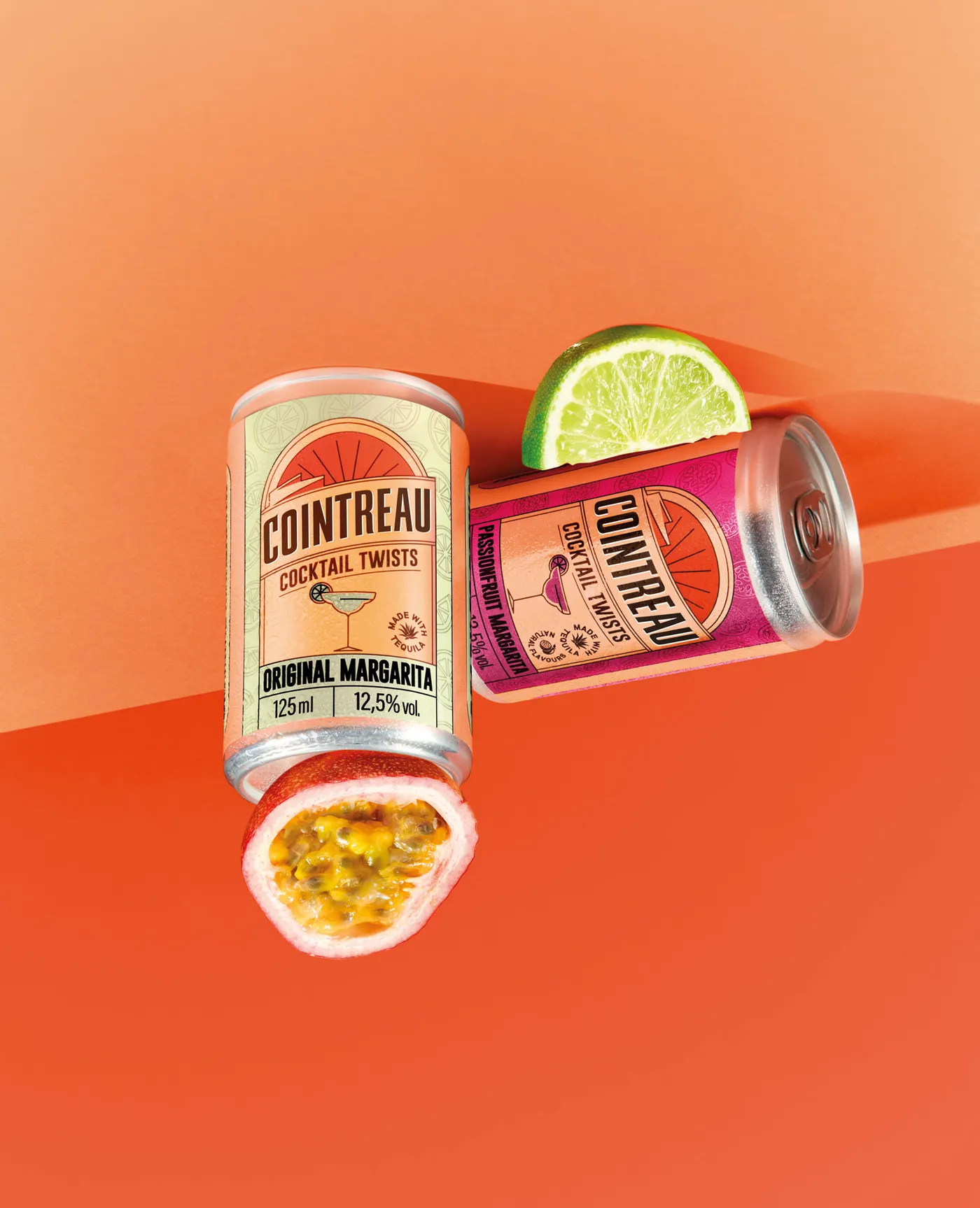 Two Cointreau Cocktail Twist cans on an orange background flipped upside down