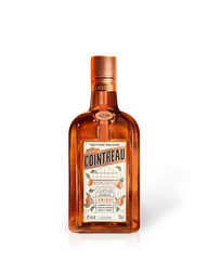Cointreau L’Unique orange liqueur bottle, amber glass with copper cap and white label, 750 ml product shot on white background.