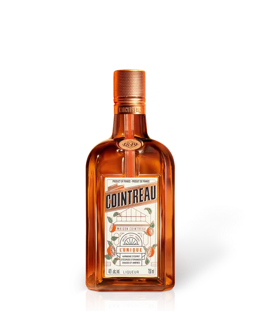 Cointreau L’Unique orange liqueur bottle, amber glass with copper cap and white label, 750 ml product shot on white background.