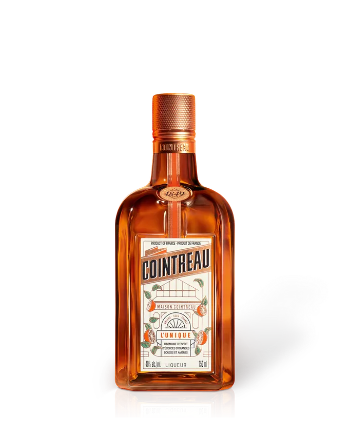 Cointreau L’Unique orange liqueur bottle, amber glass with copper cap and white label, 750 ml product shot on white background.