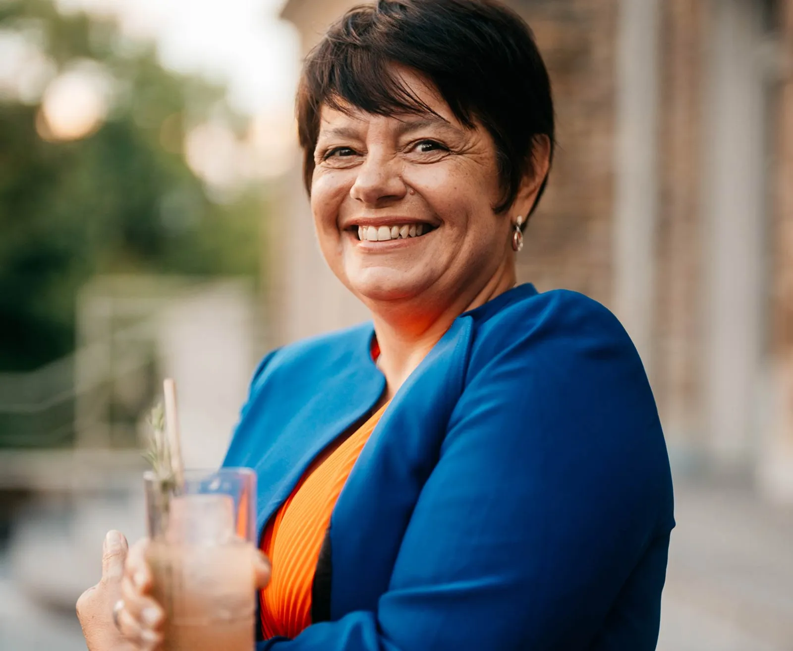 Medium shot of Master distiller Carole Quinton in front of a blurry background with bokeh
