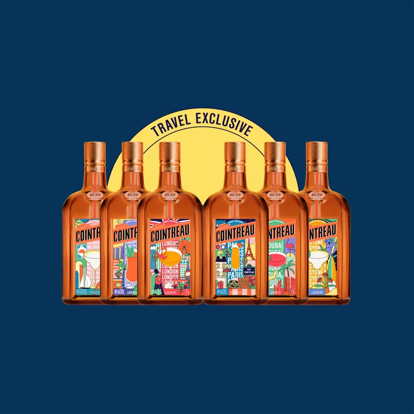6 colorful decorated bottles of Cointreau’s Key Cities Limited Edition in front of a dark blue background