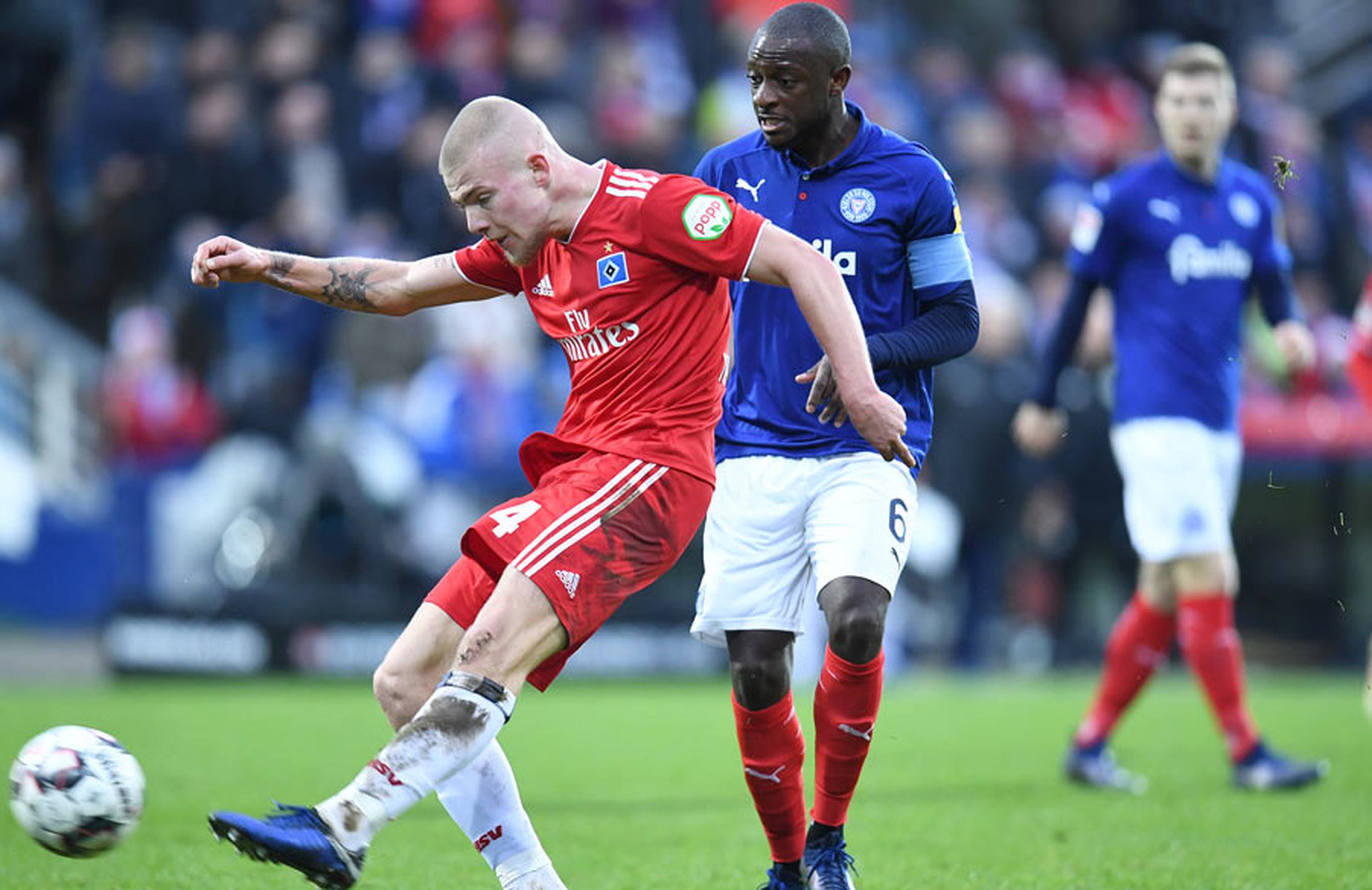 Rick van Drongelen schießt den Ball vor Gegner David Kinsombi weg.