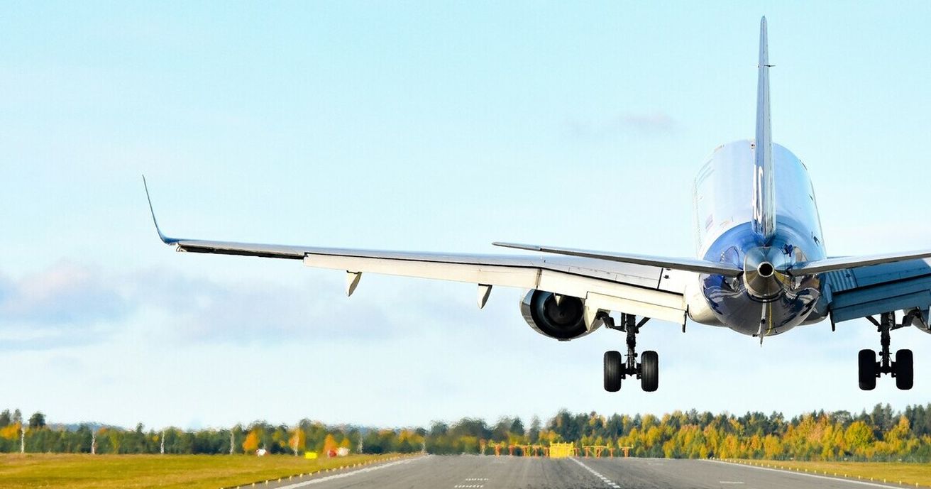 An airplane taking off and flying into a blue sky