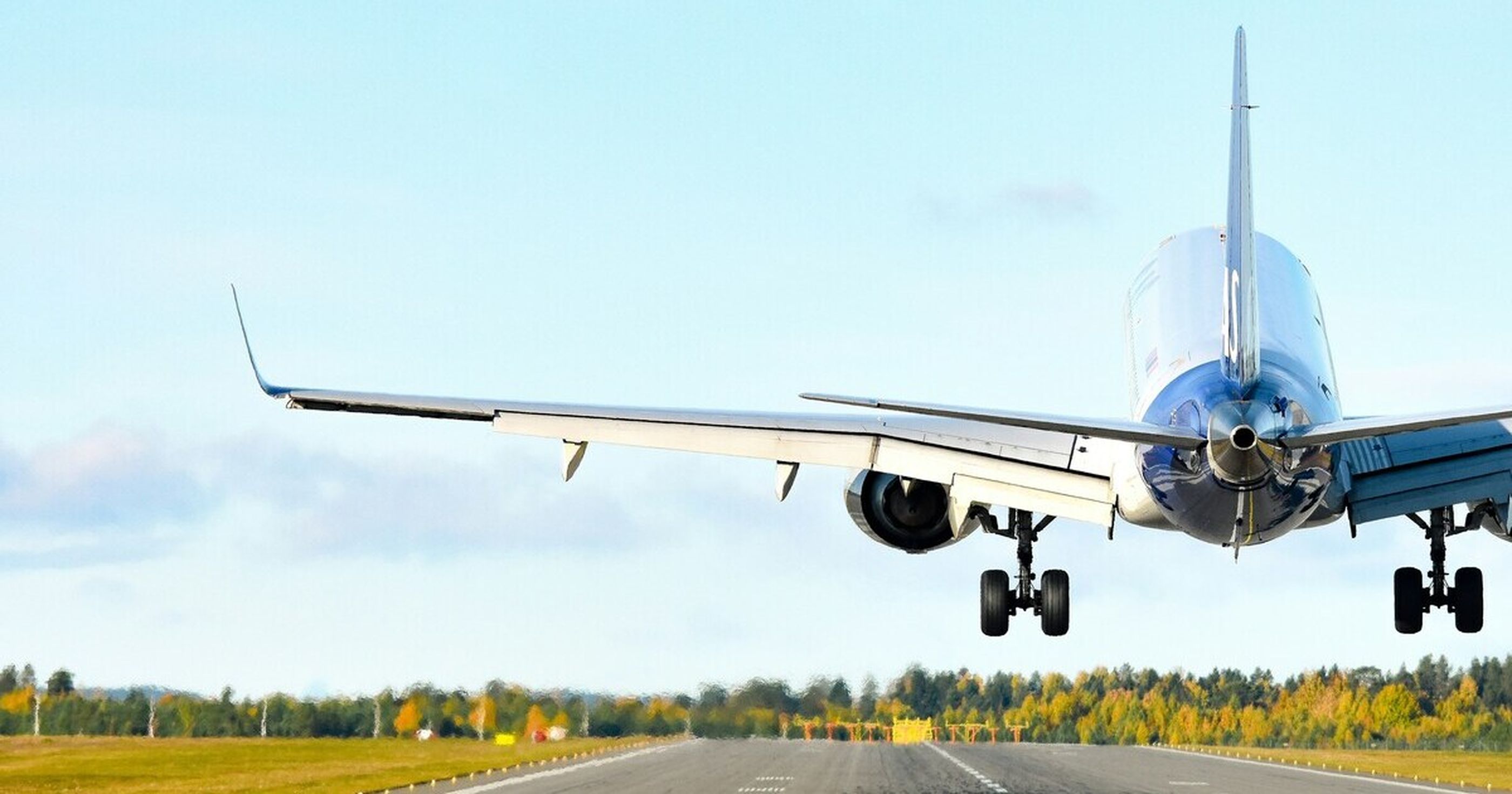 An airplane taking off and flying into a blue sky