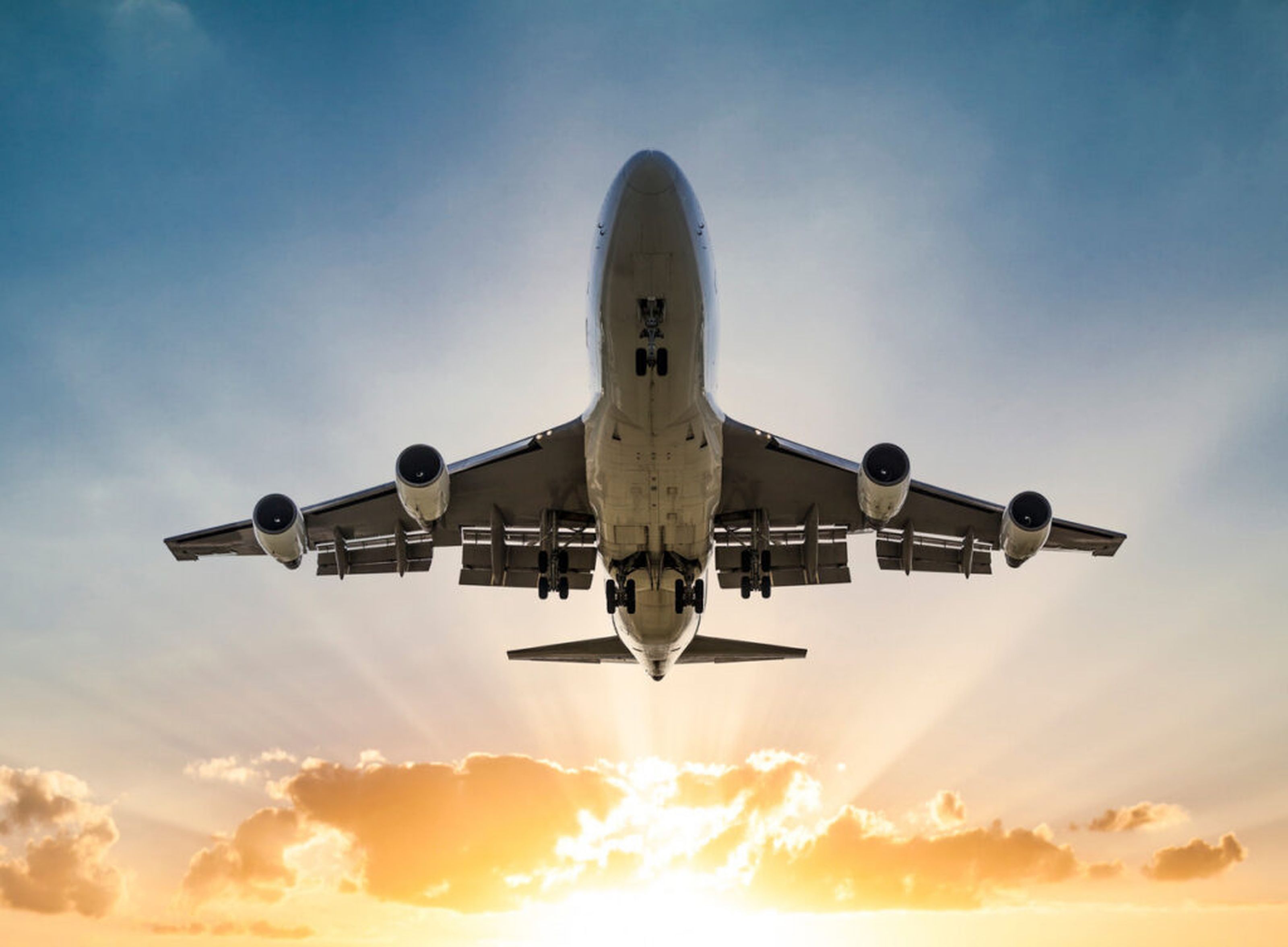 Airline flying at sunset