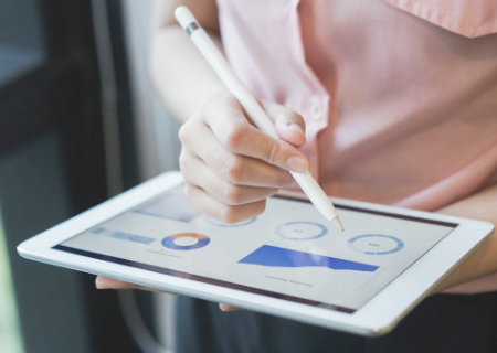 Charts and graphs displayed on a tablet.