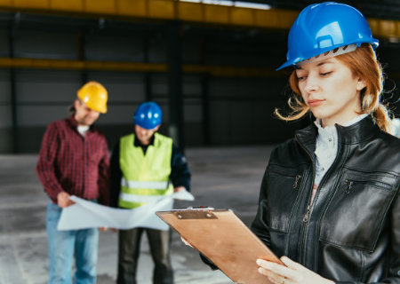 Construction workers looking at metrics.