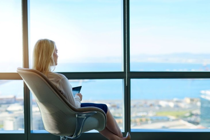 Woman Sitting At A Large Window