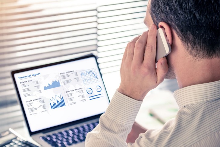On The Phone Looking At Charts And Graphs