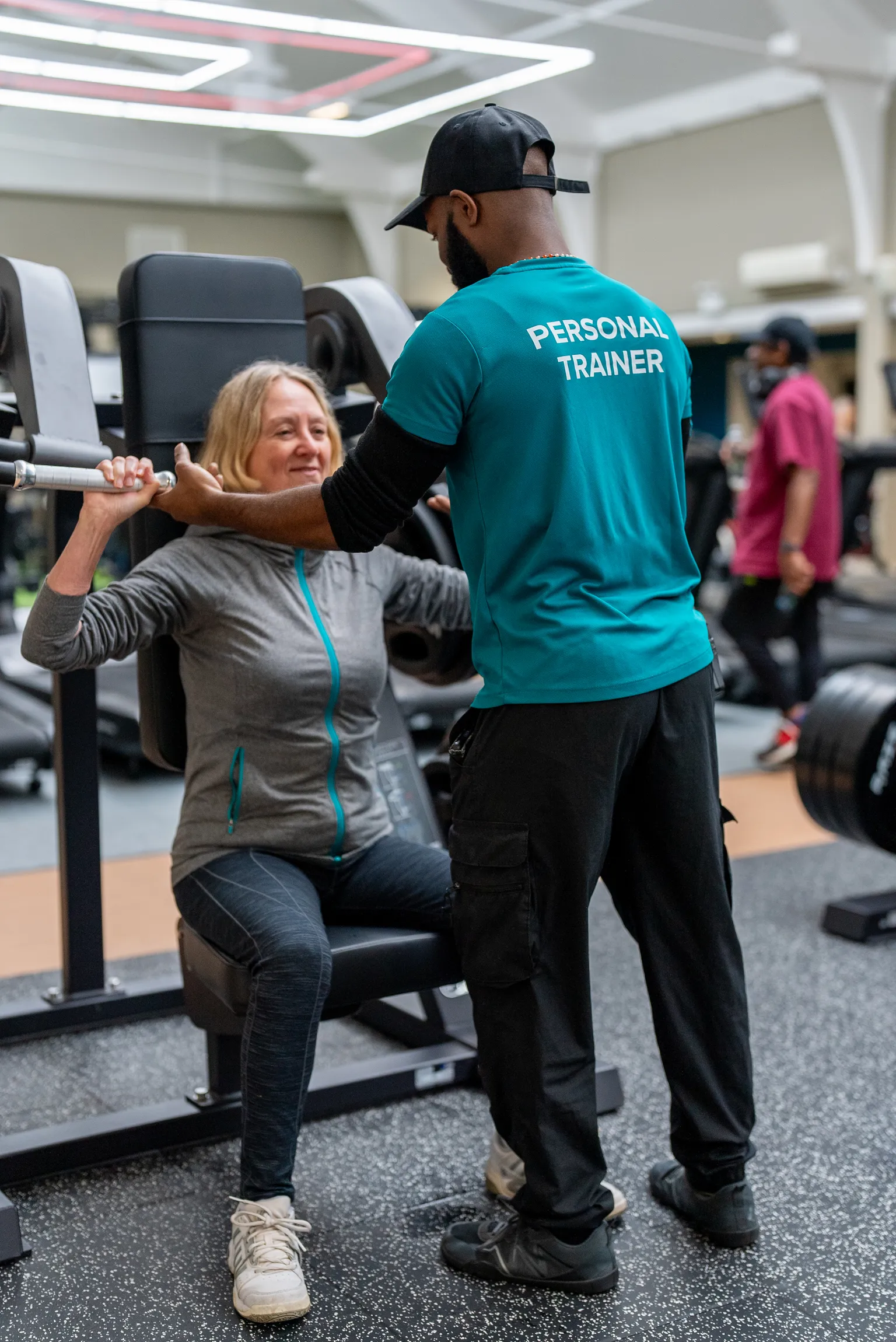 lady in gym with instructor
