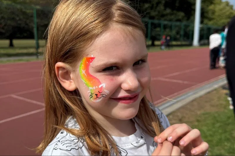 Young girl with face painted at family fun day