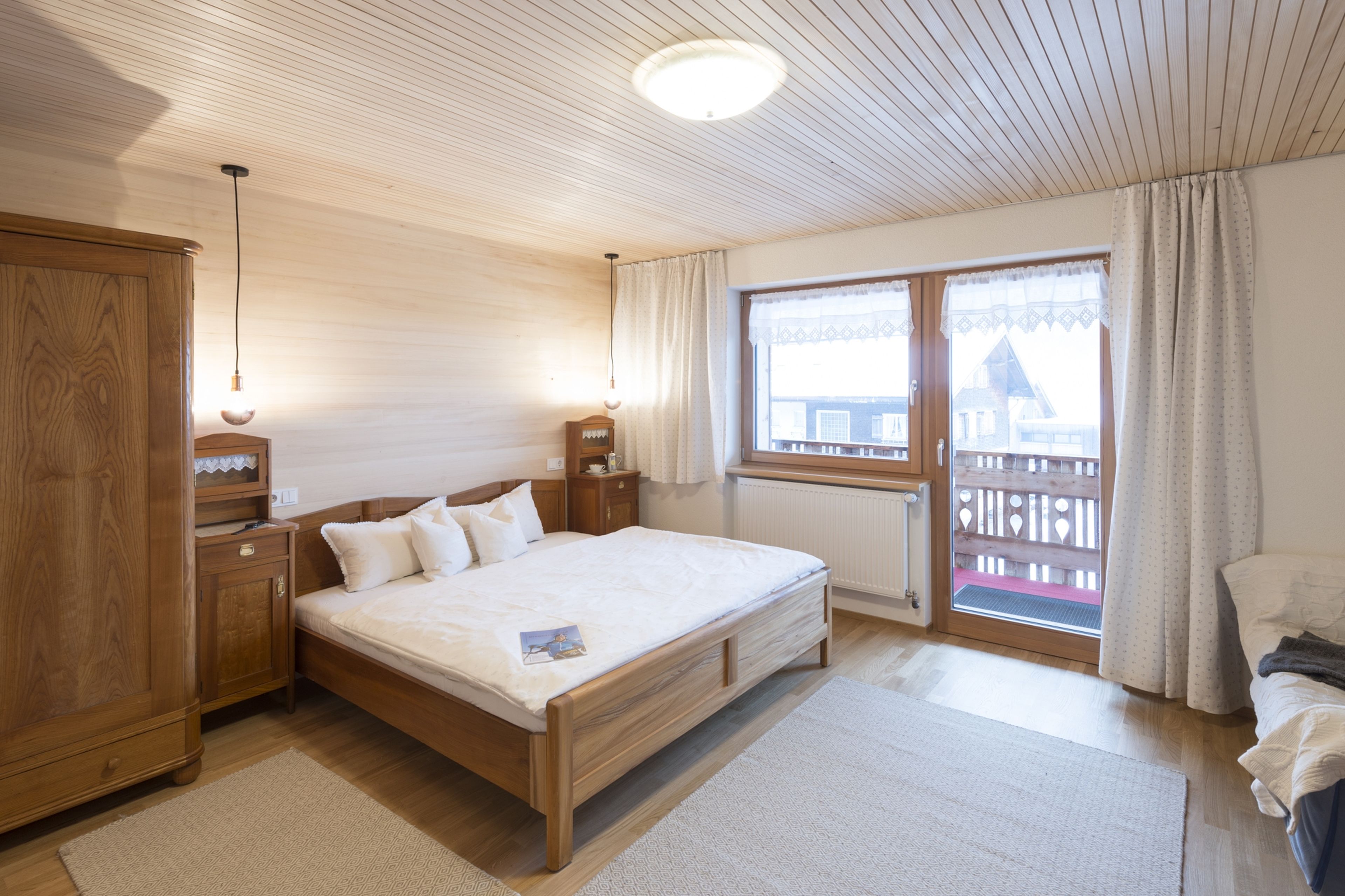 Doppelbett und Schrank und Blick auf Balkon