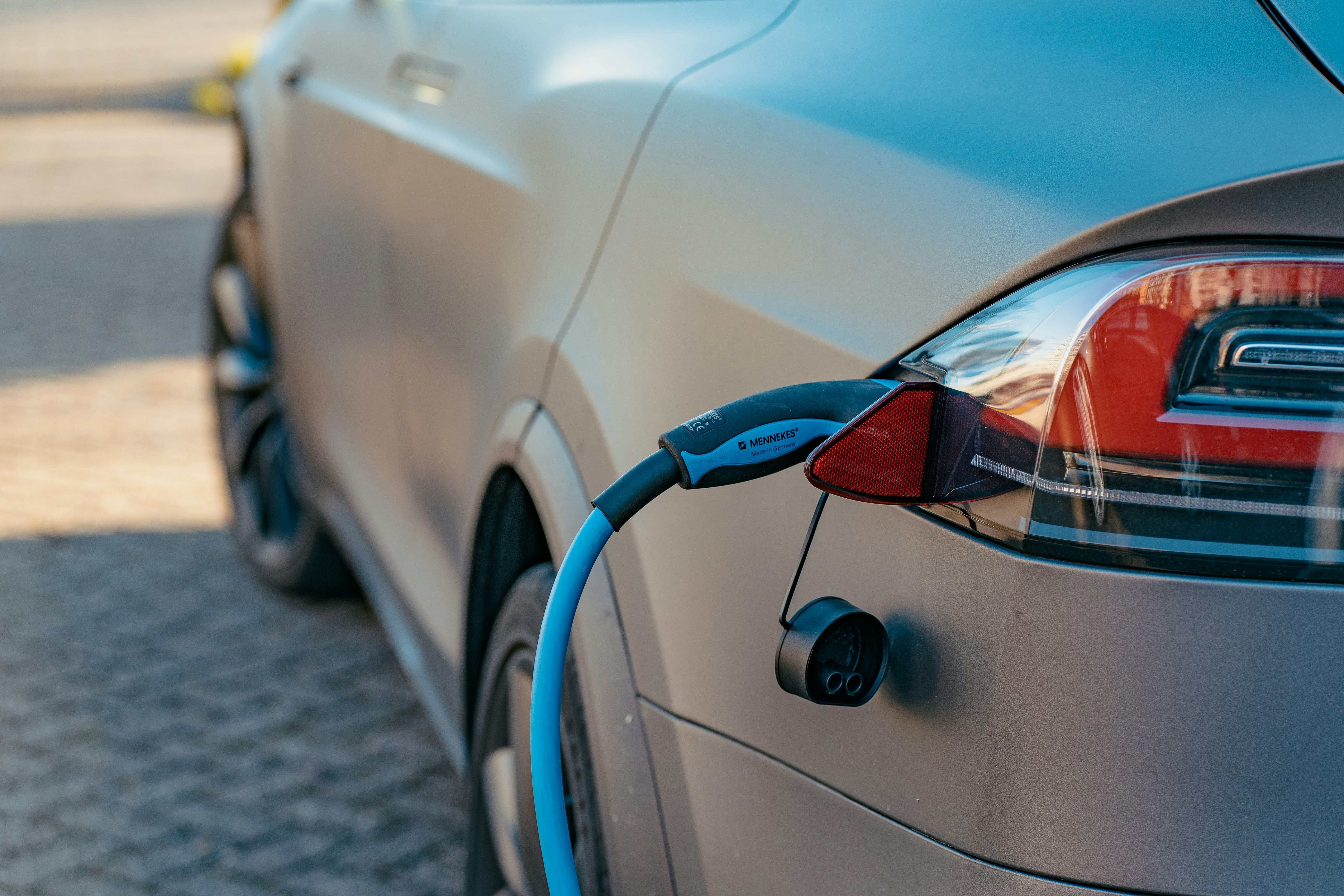 Fleet manager reviewing home charging reimbursement records for a company EV on a laptop