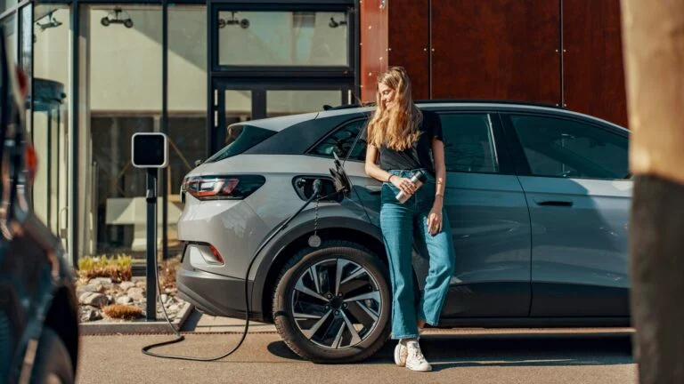 Electric company cars charging outside a corporate office, illustrating EV fleet tax advantages across Europe