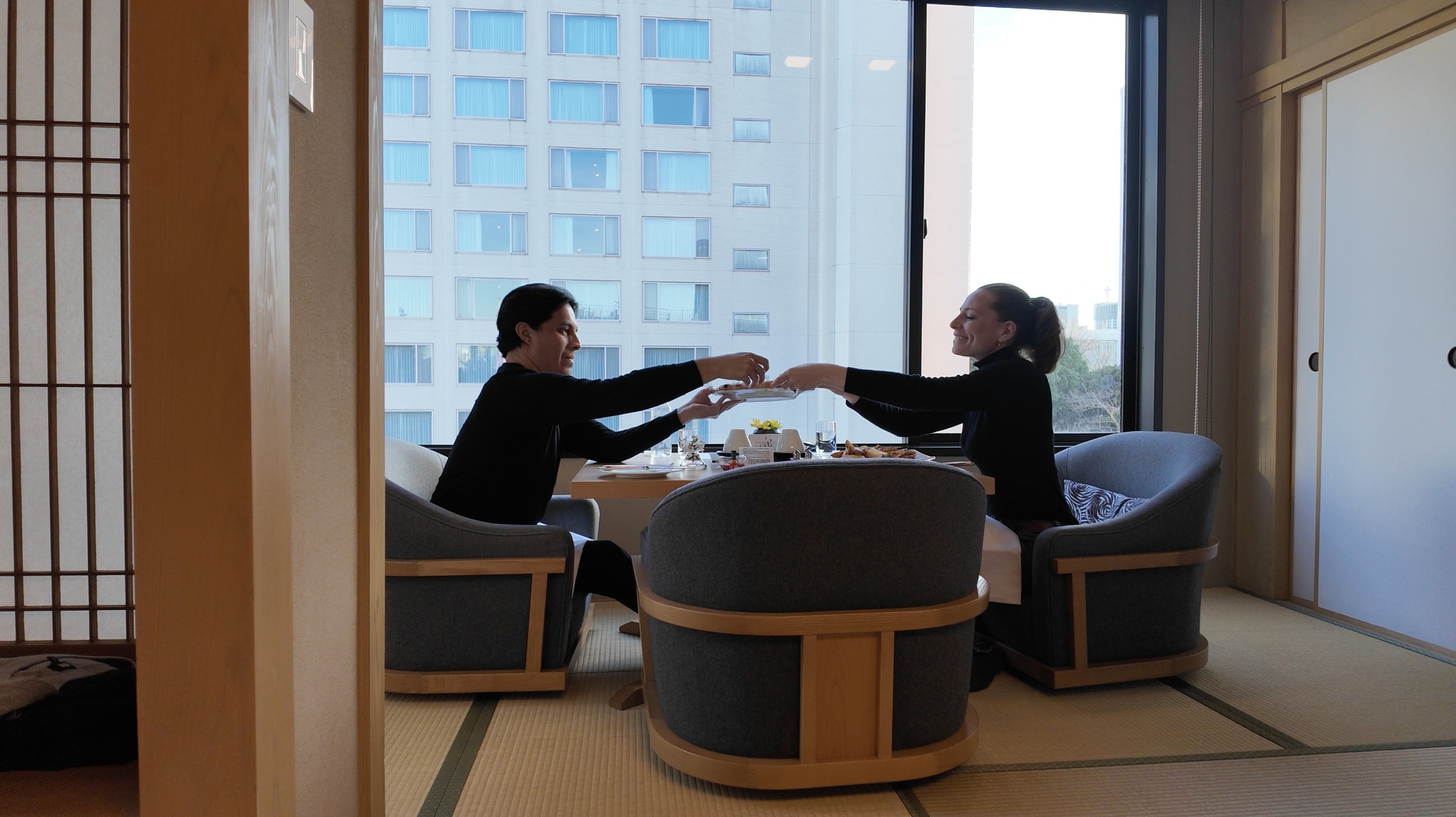 Room service with Margherita pizza, fried chicken, french fries, and drinks in a Takanawa Hanakohro suite.