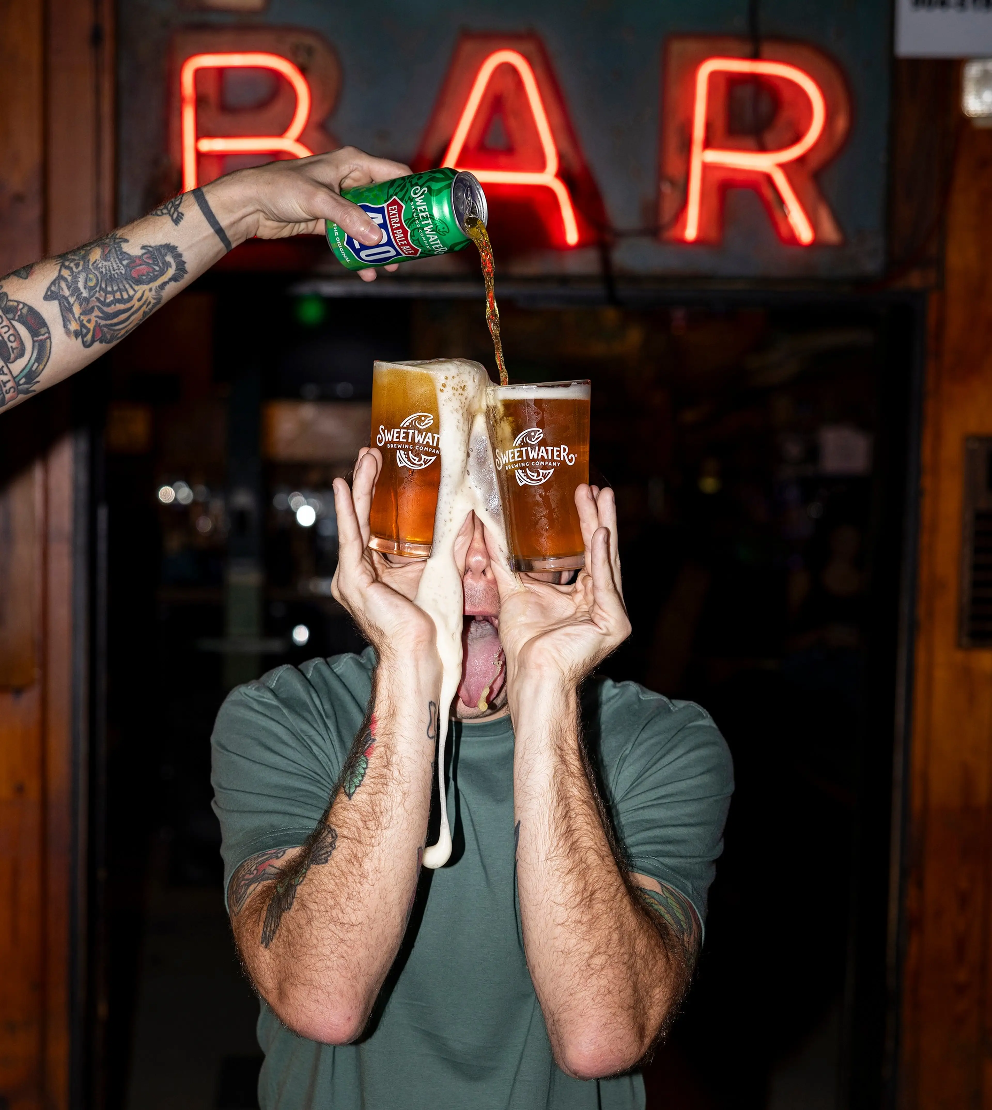 Sweetwater IPA being poured into two beer glasses