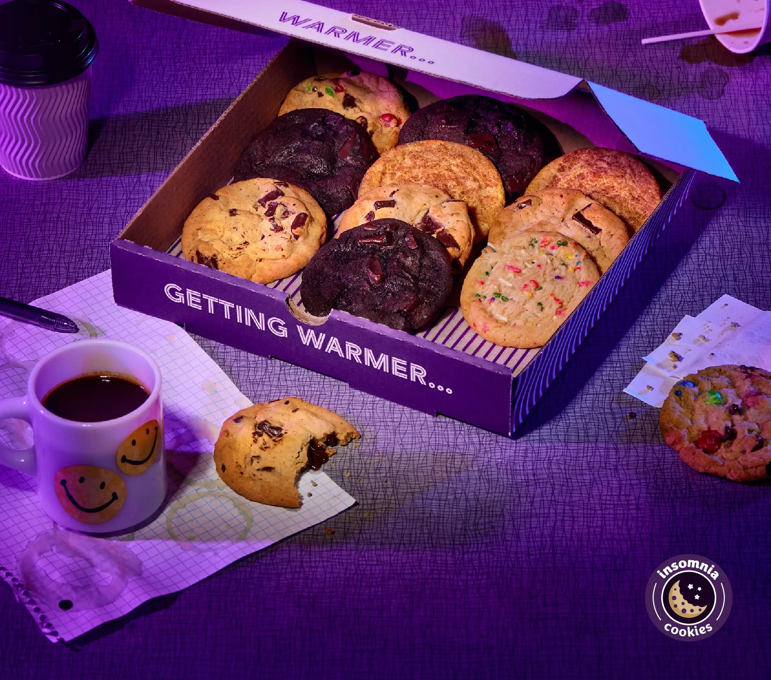 Insomnia Cookies box surrounded around study materials