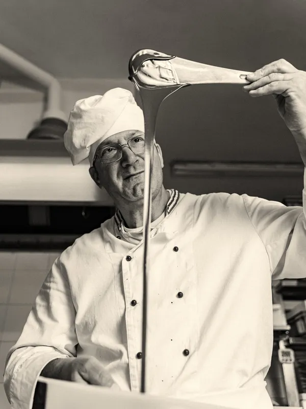 Head chef at work in a luxury hotel kitchen — Studio Cicely hospitality web design