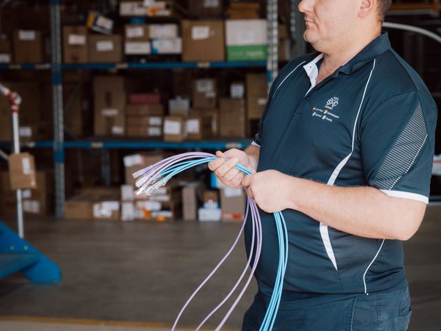 Team member sorting a bundle of network patch leads