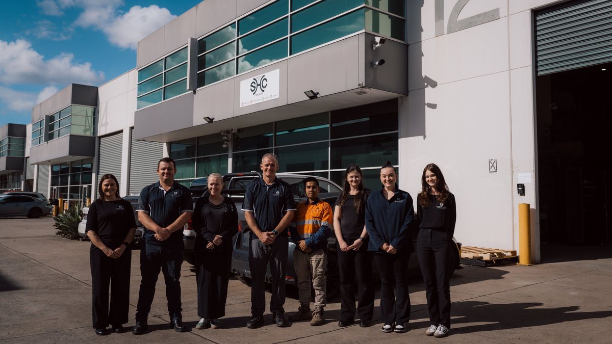 The SHC team standing outside the SHC office and warehouse