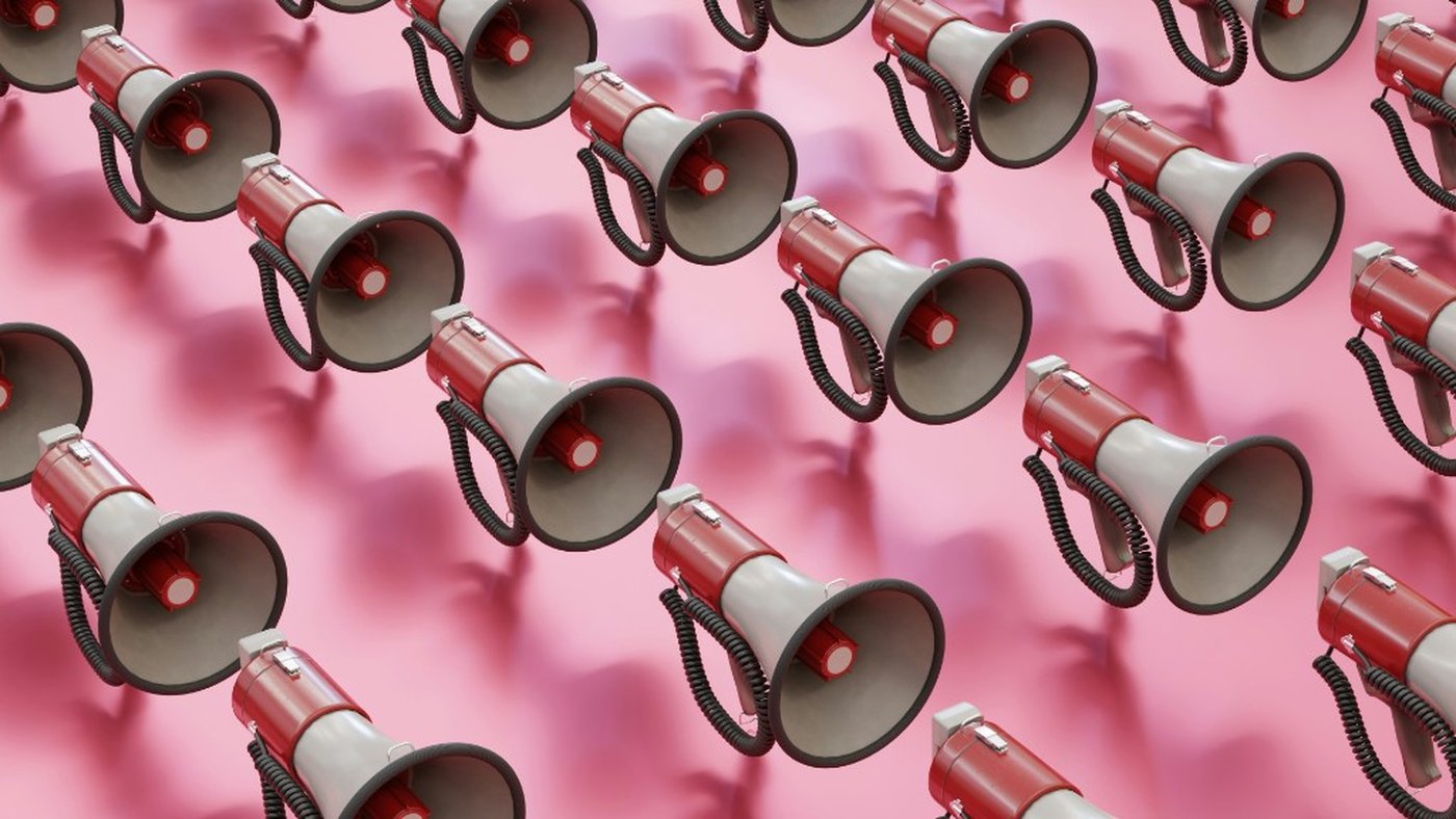 Red megaphones on pink background — branded content visual