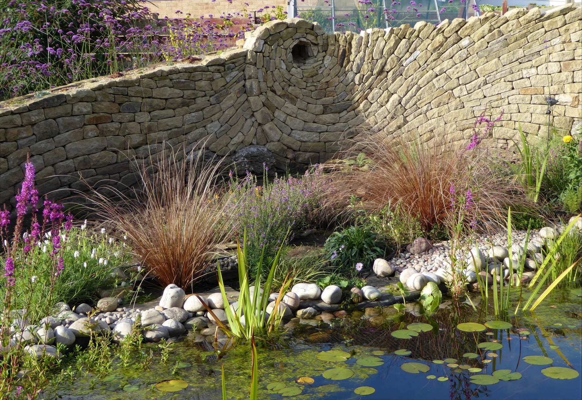 A naturalistic border of ornamental grasses and white perennials