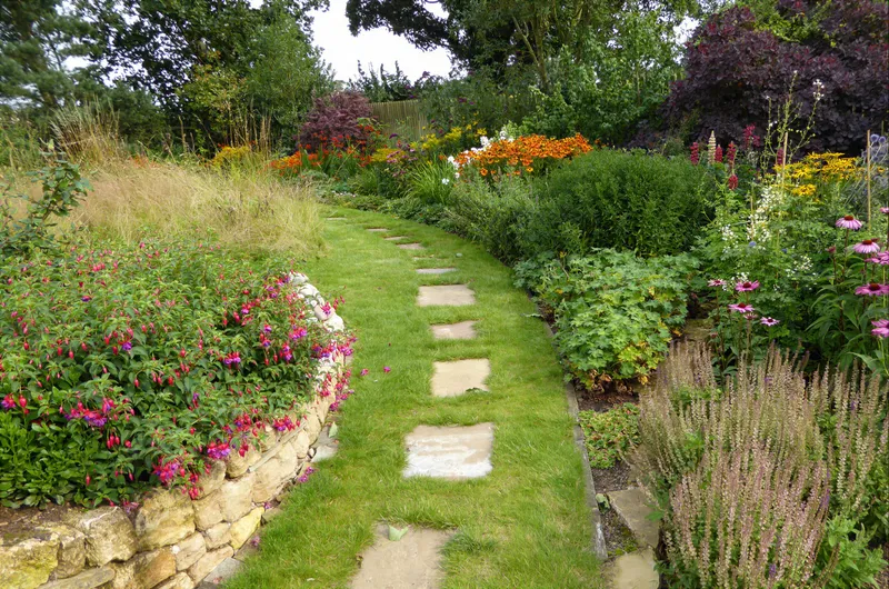 A stepping-stone path winding through planted borders
