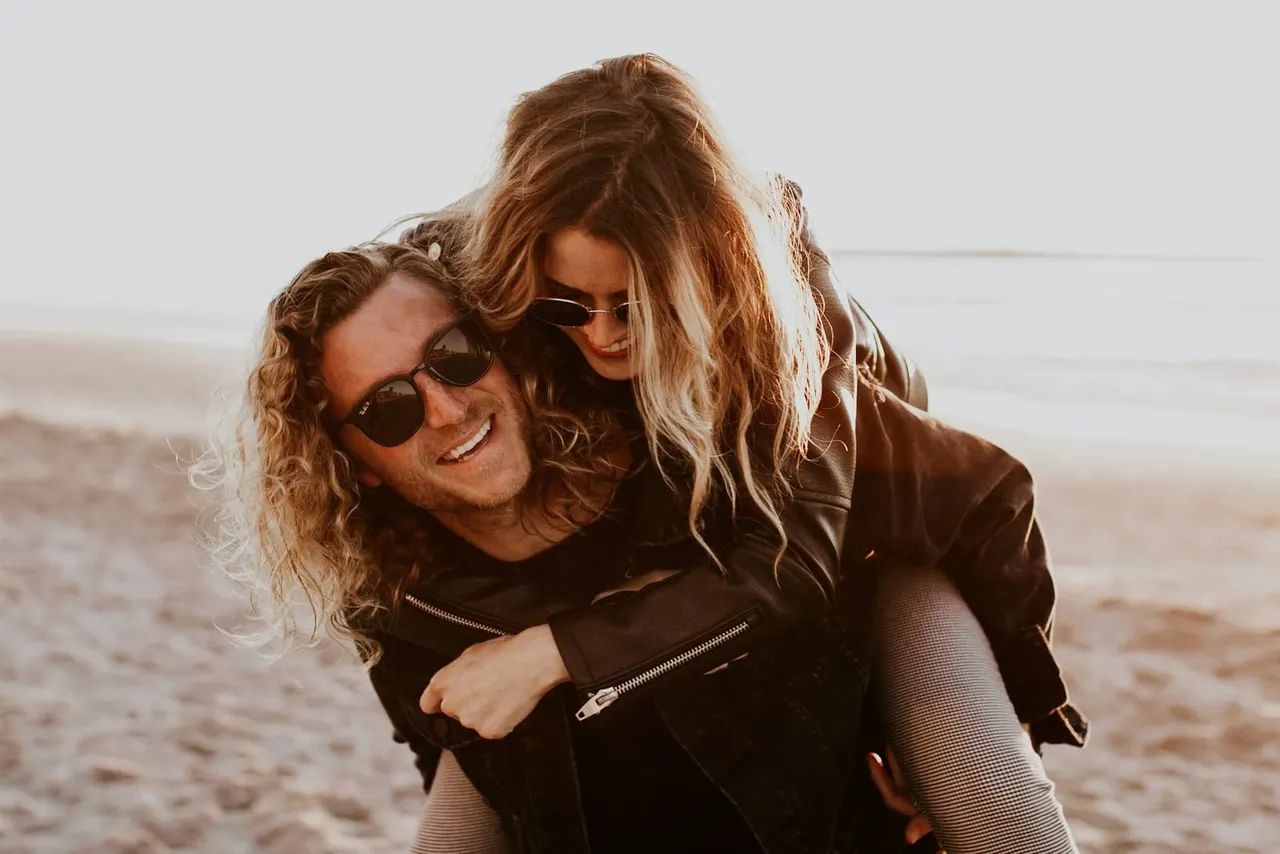 Happy couple on the beach at golden hour