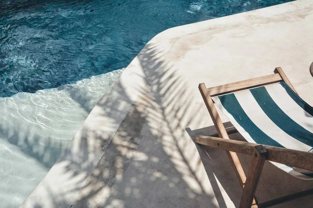 Woman relaxing poolside in sunlight