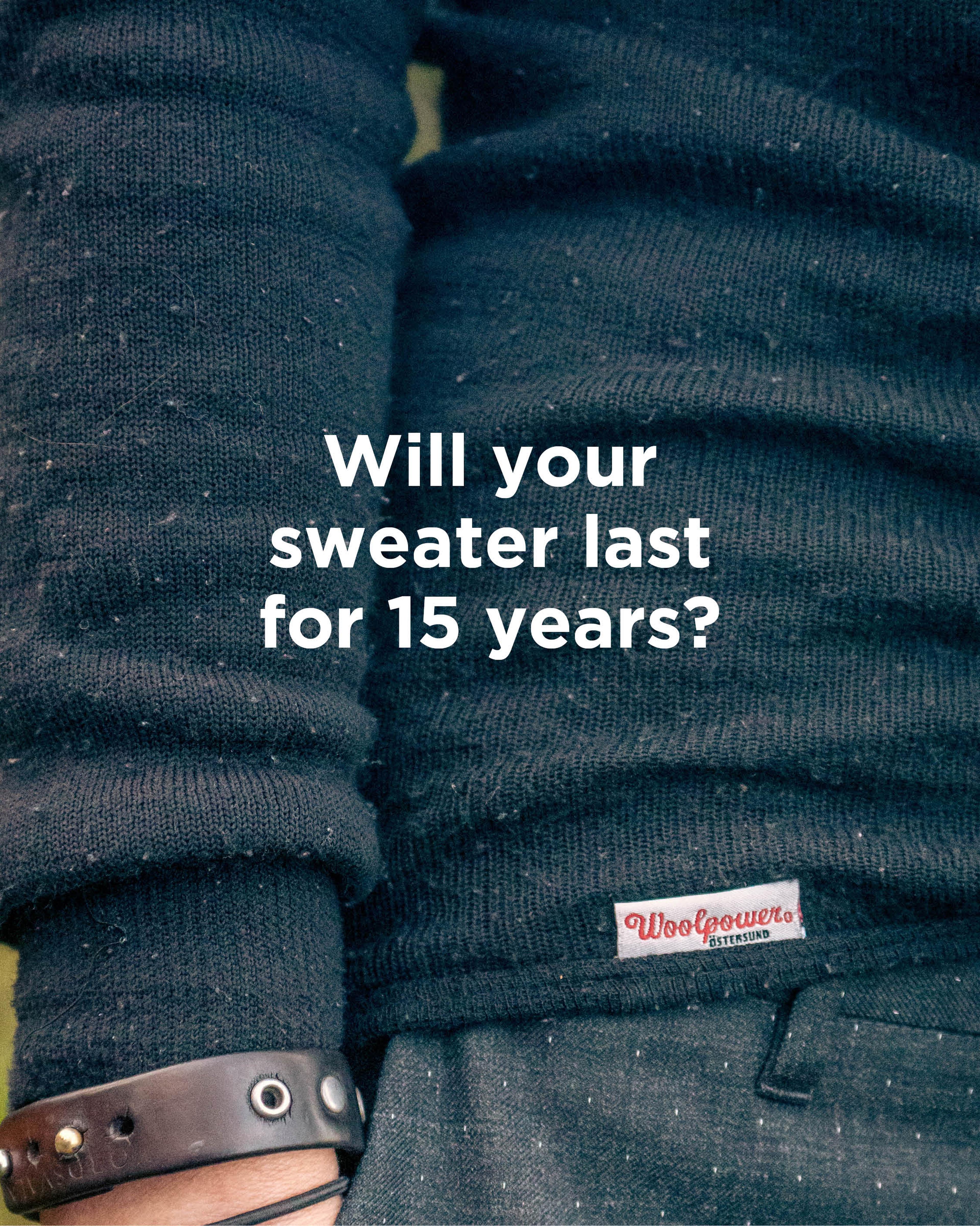 Close-up of a person wearing a black sweater with a visible Woolpower tag. Text on the image reads, "Will your sweater last for 15 years?"