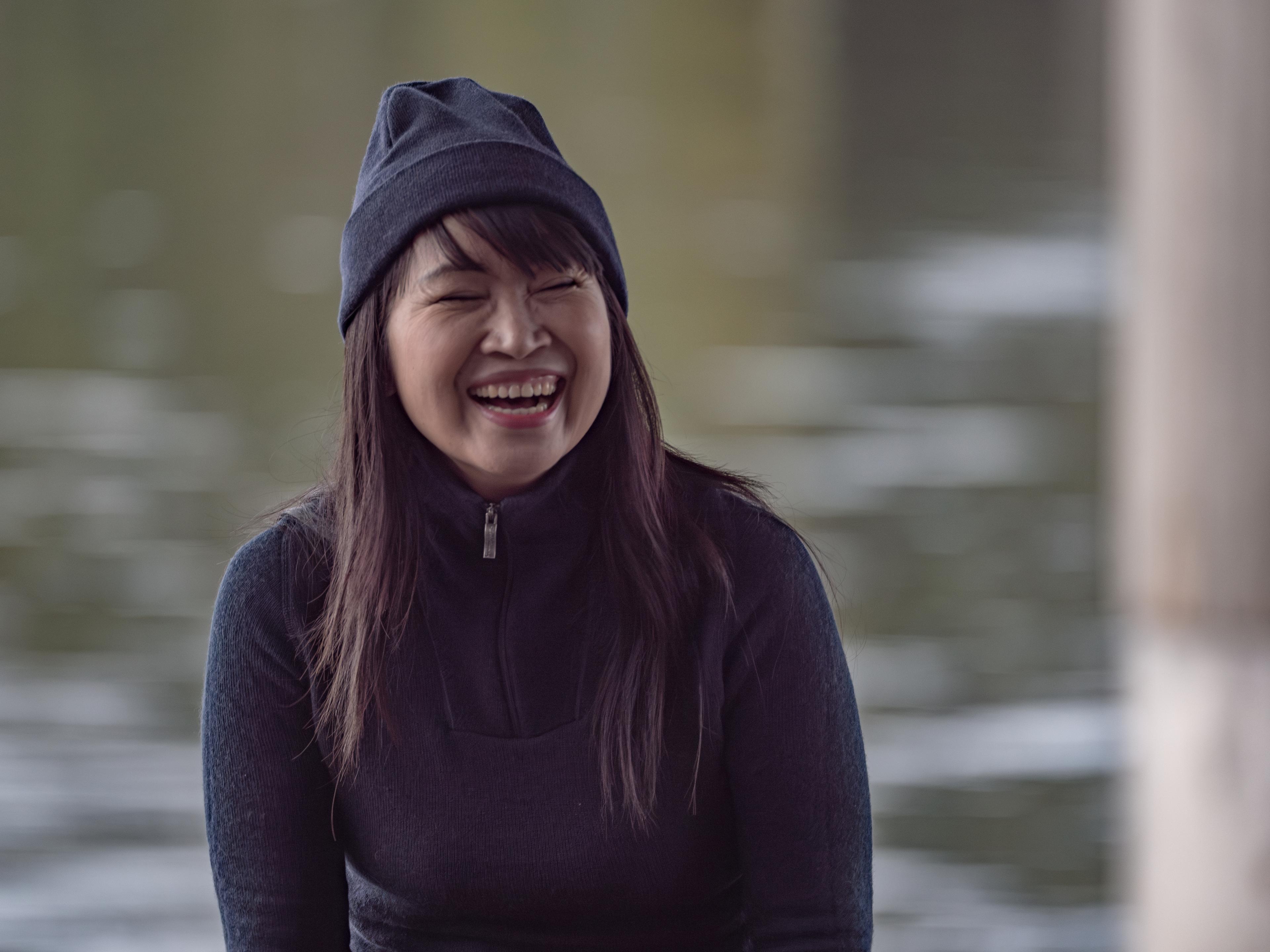 Woman laughing outside wearing the Beanie LITE in the color black
