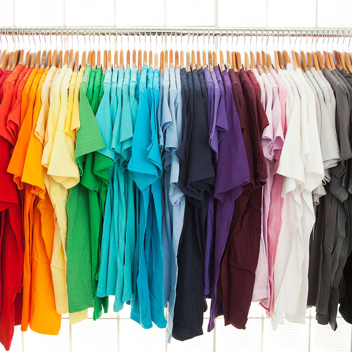 A rack of blank t-shirts in every colour, ready to be printed with artist designs
