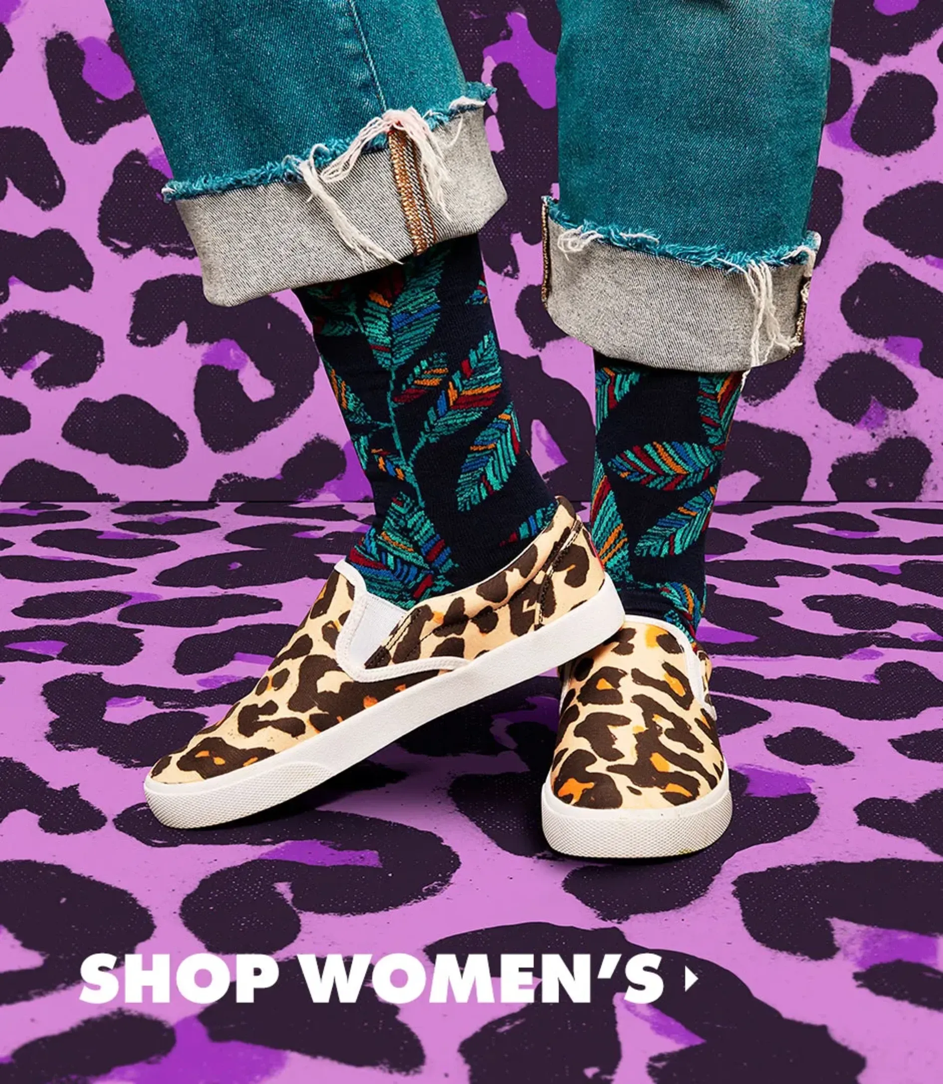 Woman in cuffed teal jeans wearing leopard print women's slip-on shoes on a purple leopard backdrop