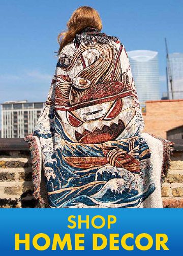 Person wrapped in a graphic blanket with a Japanese wave design on a city rooftop
