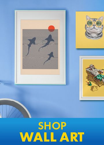 Framed wall art prints with sharks and a cat hung on a light blue wall