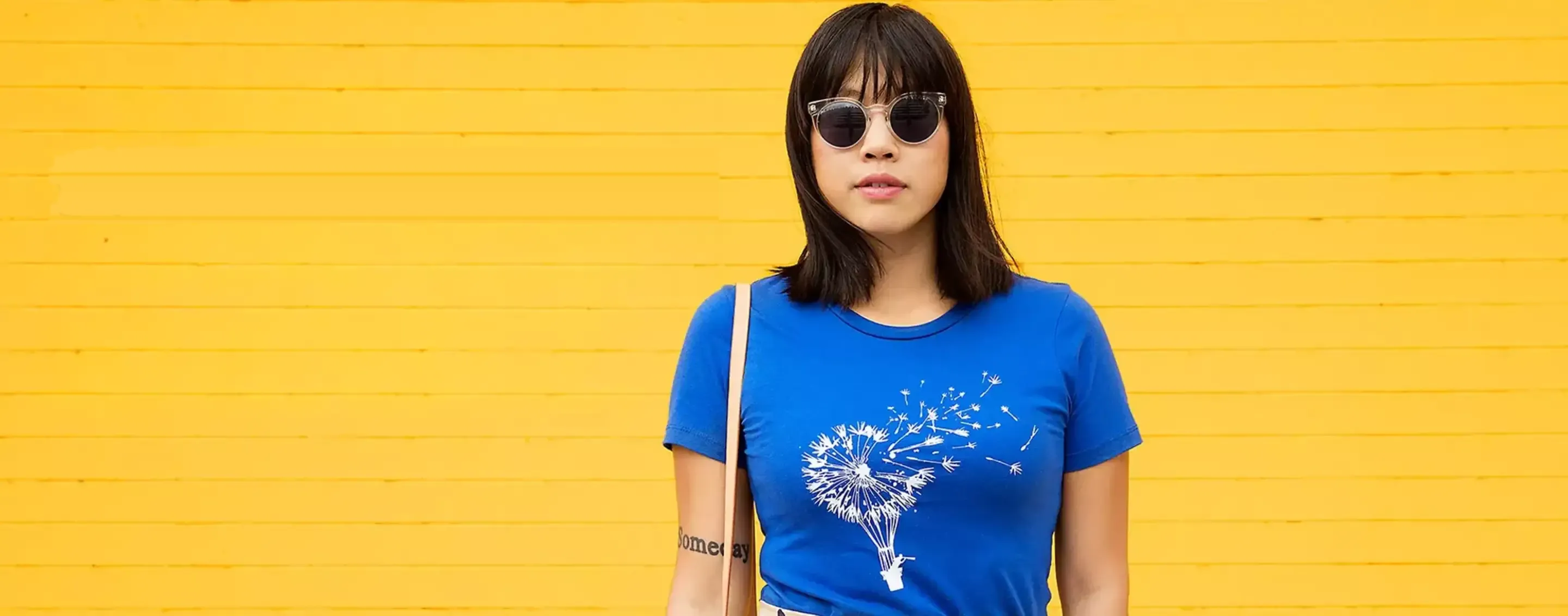 Woman wearing a blue dandelion graphic t-shirt from Threadless