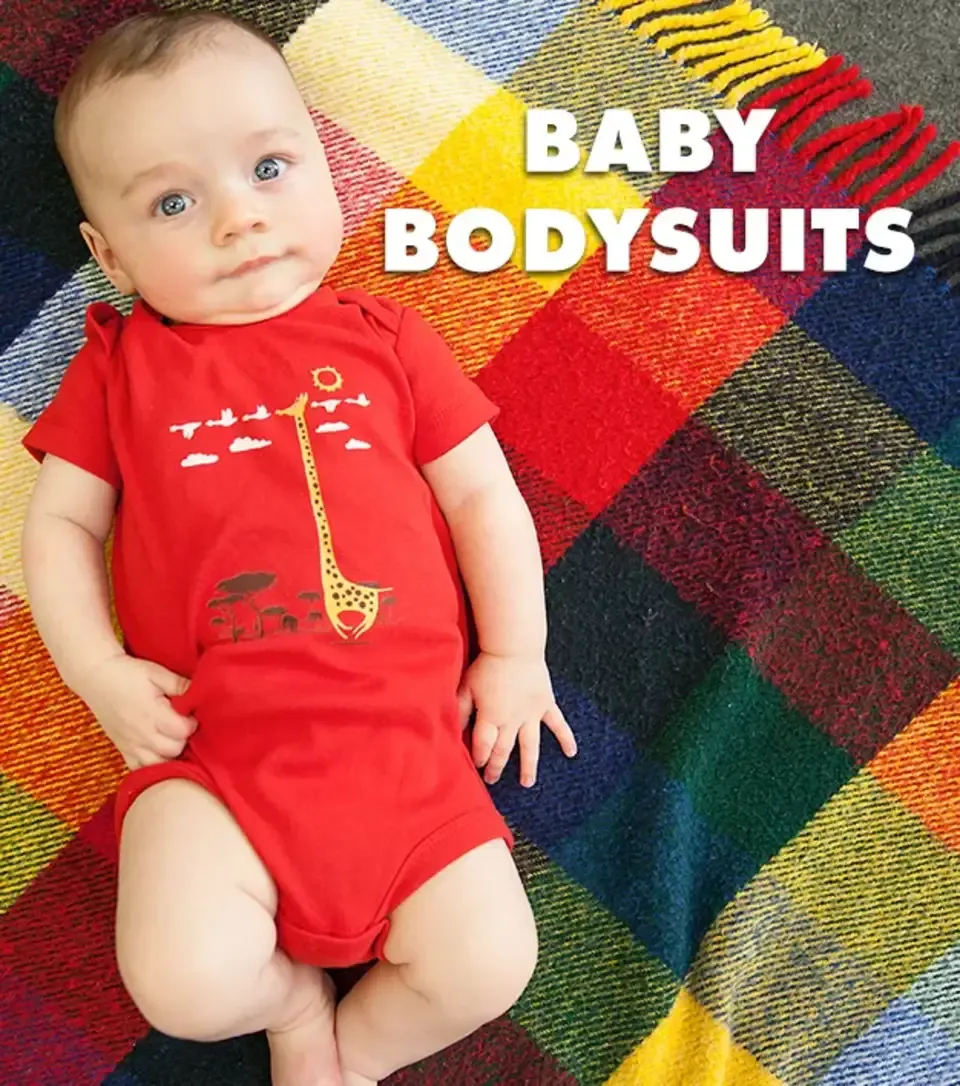 Baby in red onesie with arrow shower graphic lying on plaid blanket labelled 'Baby Bodysuits'.