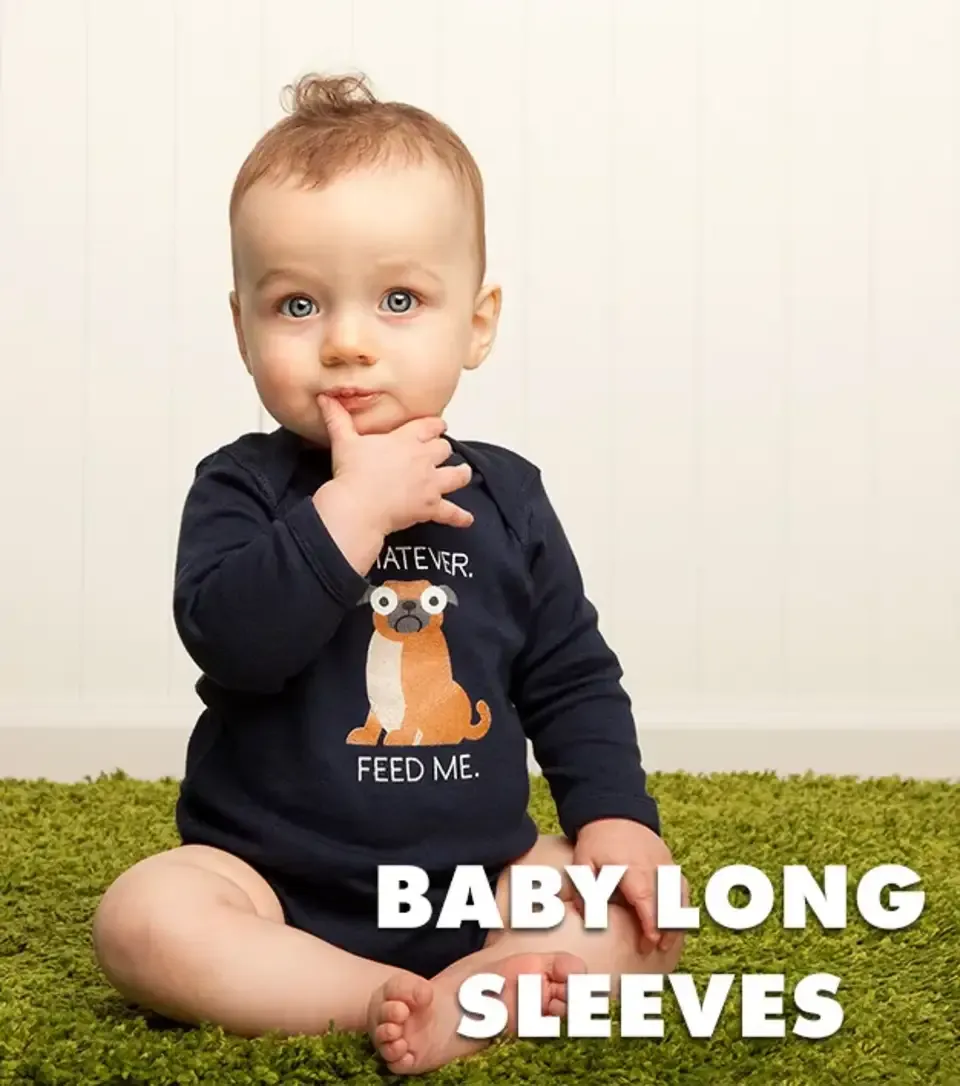 Baby in navy long sleeve onesie with sad dog 'Whatever Feed Me' graphic sitting on green rug labelled 'Baby Long Sleeves'.