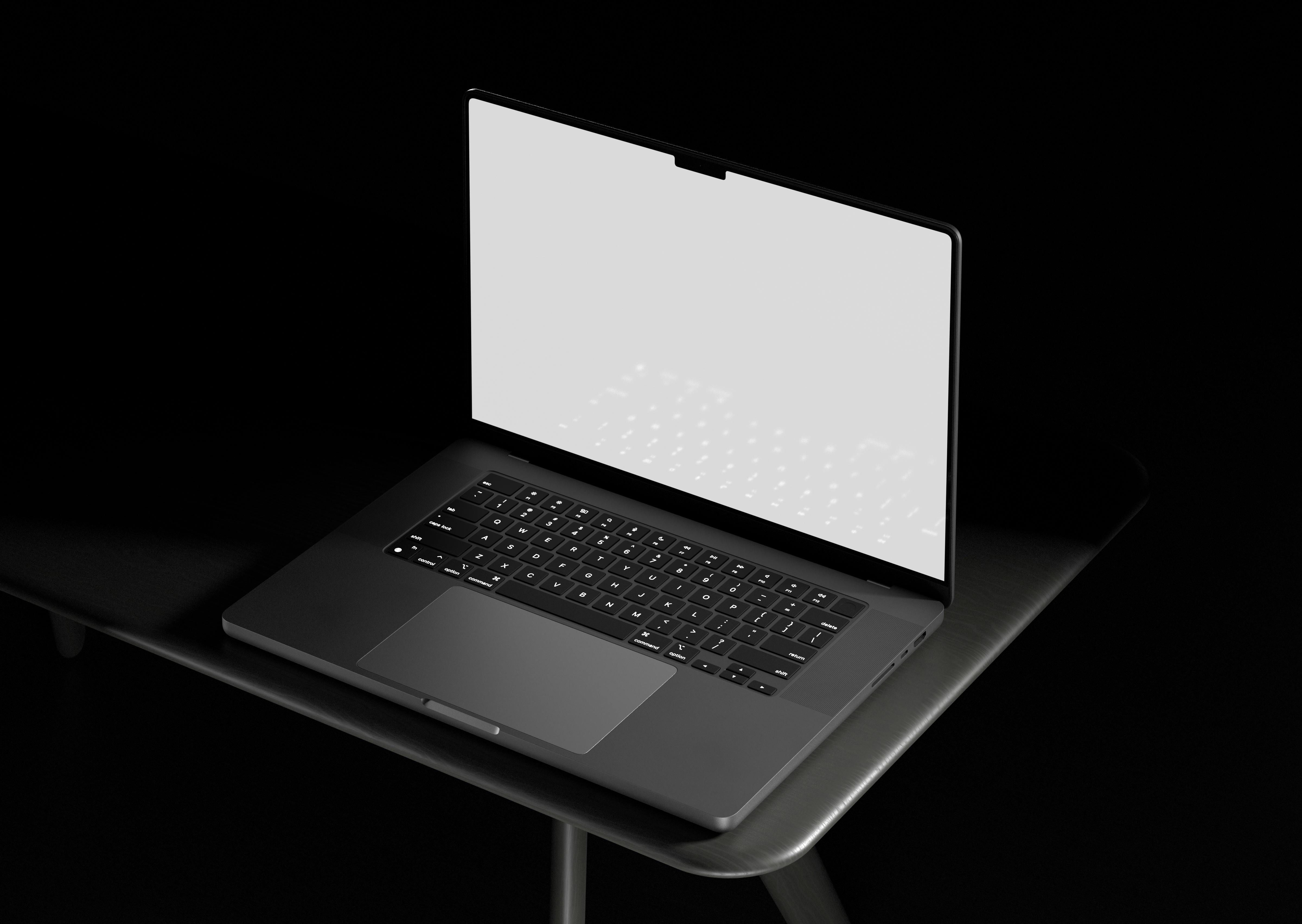 Offenes Laptop auf einem dunklen Tisch, schwarzes Gehäuse, Bildschirm weiß, von oben betrachtet in schwarzem Hintergrund.