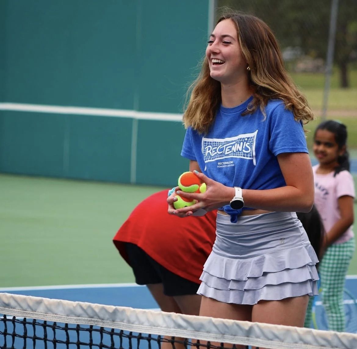 Lucy Erickson feeding tennis balls at a RecTennis Summer Camp in Oregon