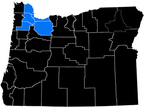 Map highlighting several counties in northwestern Oregon in blue against a black background.