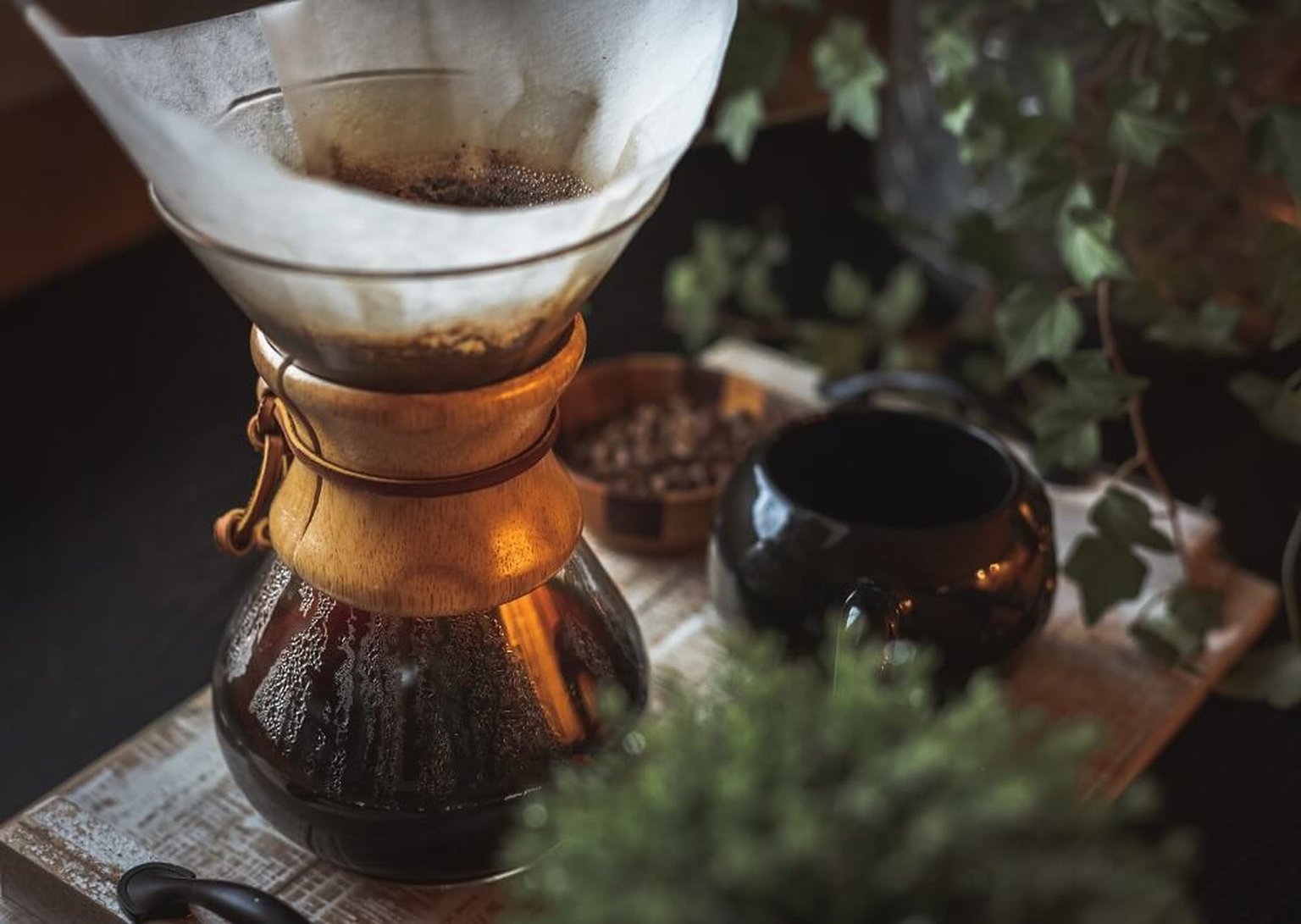 Chemex Bonded filters and a gooseneck kettle next to a Chemex brewer on a kitchen counter.