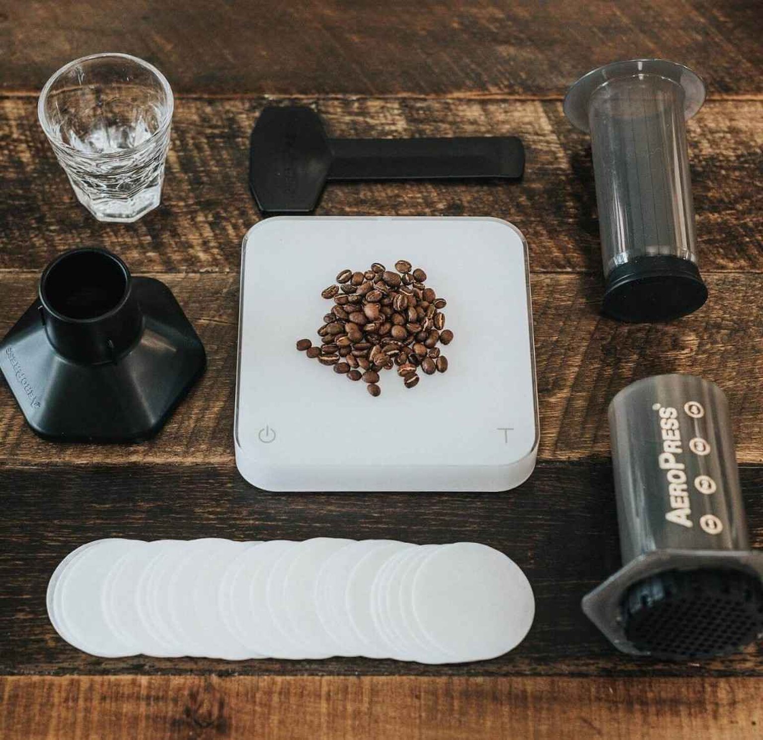 AeroPress Go travel coffee maker next to a mug, ready for brewing on the go.