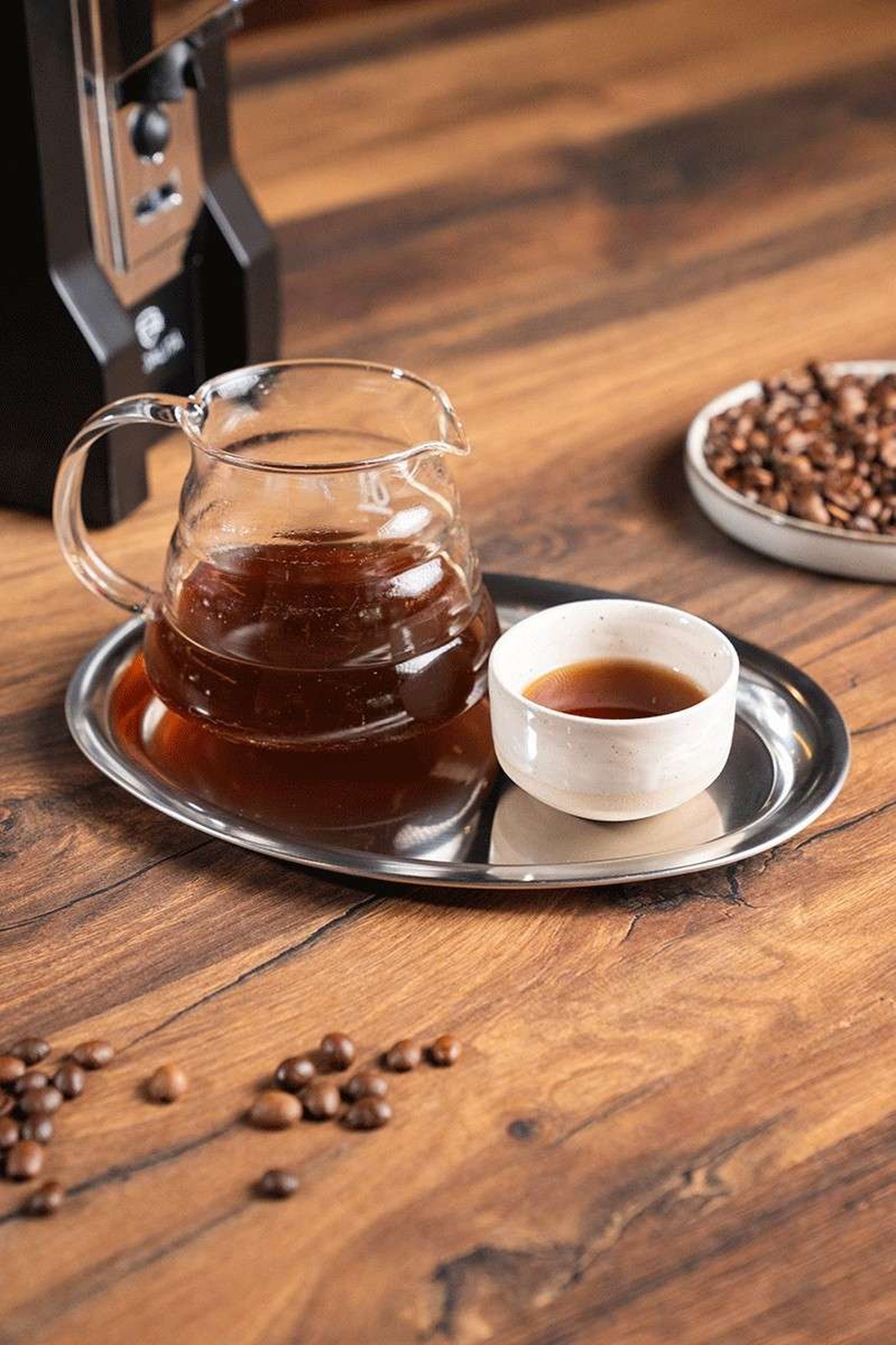 Glass syphon coffee maker during manual coffee preparation.